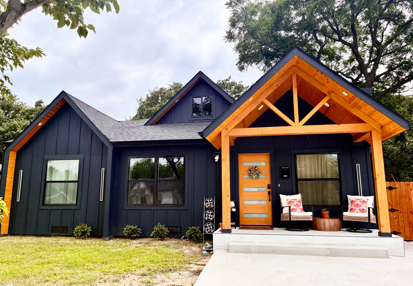 Casa by the Creek's navy exterior, gold front door, and welcoming porch