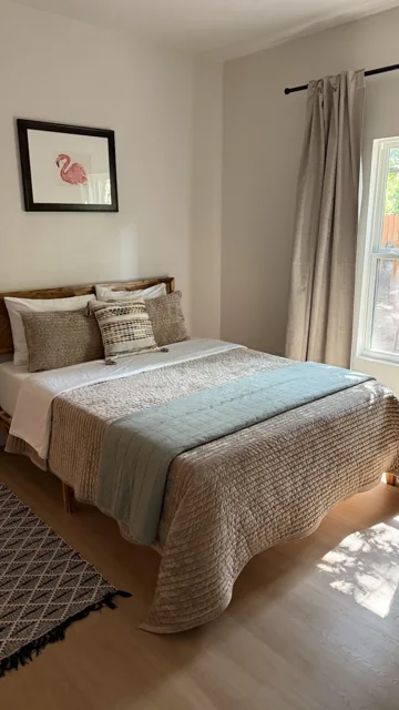 Room 4 with natural wood and pale green bedding